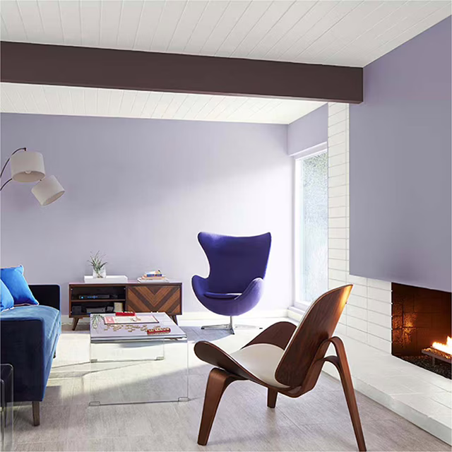 สีทาห้องนั่งเล่นสีม่วง จาก Benjamin Moore ให้บรรยากาศอบอุ่นผ่อนคลาย แต่มีความโดดเด่นในตัว
